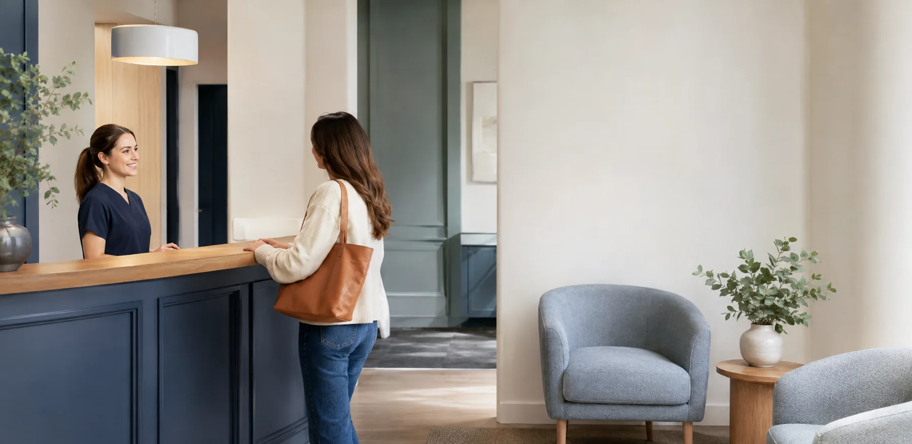 Patient being welcomed at a calm modern dental reception desk